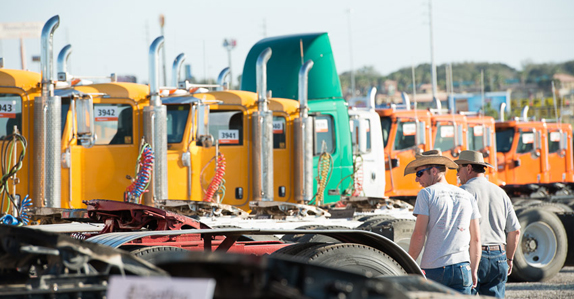 Equipment buyers inspecting trucks